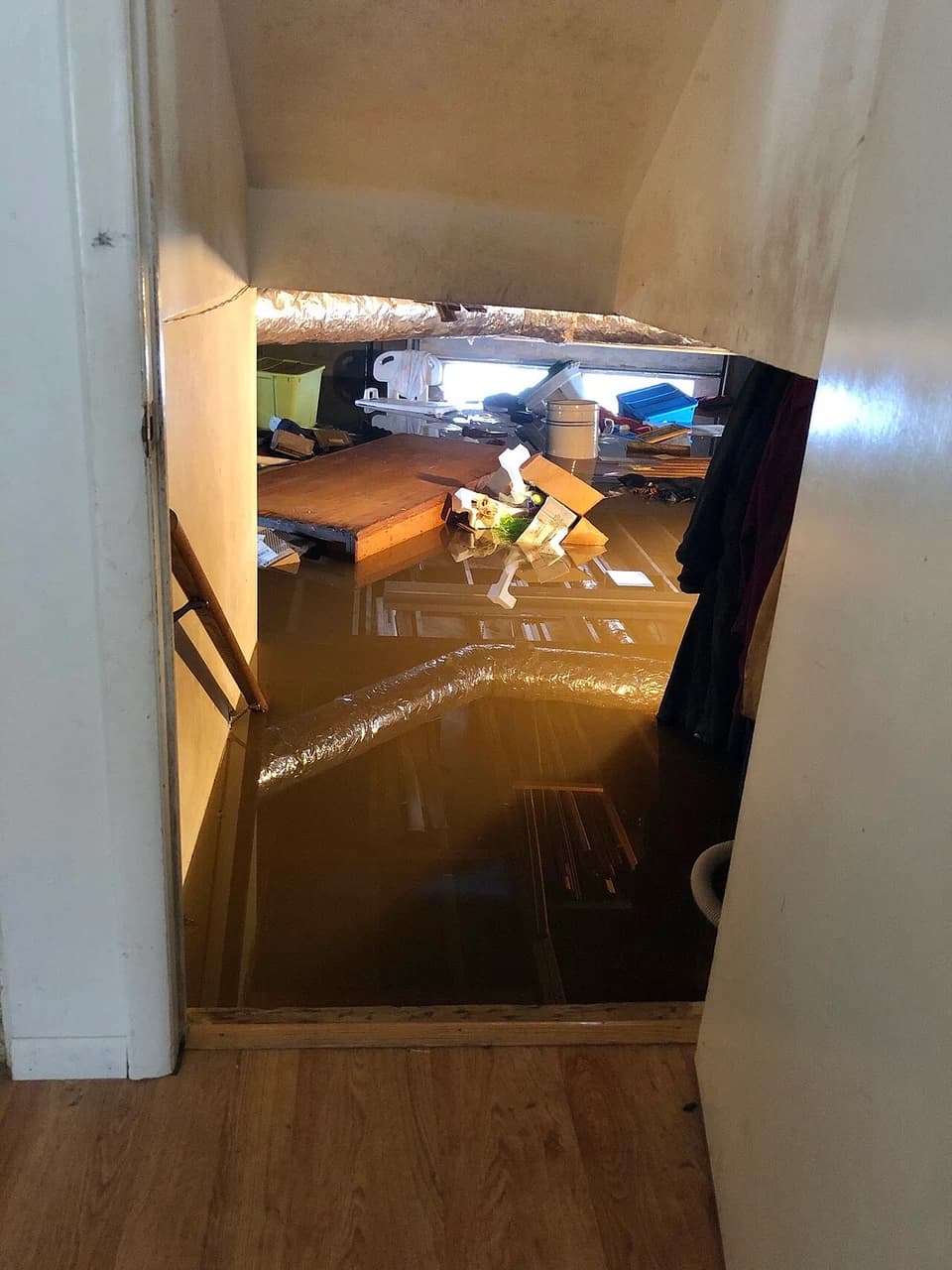 En oversvømt kjeller sett fra trappen i huset.